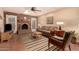 Cozy living room with brick fireplace, comfortable seating, and tiled flooring at 3226 E Lazy Ln, Phoenix, AZ 85028