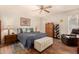 Inviting main bedroom with a ceiling fan, wood floors, and comfortable furnishings at 3226 E Lazy Ln, Phoenix, AZ 85028