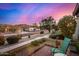 Charming street view with lush landscaping, mountain views and chair on front patio at 3226 E Lazy Ln, Phoenix, AZ 85028