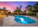 Sparkling swimming pool and patio area, surrounded by lush landscaping and outdoor seating at 3226 E Lazy Ln, Phoenix, AZ 85028