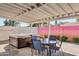 Backyard area featuring a modern hot tub, outdoor seating, and a colorful privacy wall at 3326 N 82Nd Pl, Scottsdale, AZ 85251