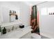 Updated bathroom with stylish fixtures, a white vanity, and a shower-tub combo with a decorative curtain at 3326 N 82Nd Pl, Scottsdale, AZ 85251