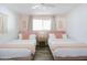 Charming bedroom with two twin beds, pink accents, and bright natural light at 3326 N 82Nd Pl, Scottsdale, AZ 85251