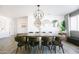 Bright dining room features a large wooden table, pendant lighting, and modern decor at 3326 N 82Nd Pl, Scottsdale, AZ 85251