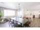 Spacious dining room connecting to modern kitchen, boasting large table, stylish light fixture and seating at 3326 N 82Nd Pl, Scottsdale, AZ 85251
