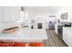Well-lit kitchen with white cabinets, quartz countertops, stainless steel appliances and breakfast bar at 3326 N 82Nd Pl, Scottsdale, AZ 85251