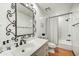 Well-lit bathroom with a single sink vanity, decorative mirror and shower-tub combo at 3500 E Lincoln Dr # 6, Phoenix, AZ 85018