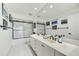 Bathroom features double sinks, black fixtures, and a glass-enclosed shower-tub combo at 3500 E Lincoln Dr # 6, Phoenix, AZ 85018