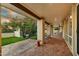 An elegant covered patio featuring stone floors, decorative columns, and a view of the lush backyard at 3500 E Lincoln Dr # 6, Phoenix, AZ 85018