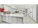 Bright kitchen features white cabinets, countertops and white tile flooring, and modern appliances at 3500 E Lincoln Dr # 6, Phoenix, AZ 85018