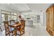 Bright kitchen with a large center island, white cabinets, and a dining area with outside view at 3500 E Lincoln Dr # 6, Phoenix, AZ 85018