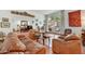 Bright living room featuring a large window, comfortable seating, and terra cotta flooring at 3500 E Lincoln Dr # 6, Phoenix, AZ 85018