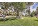 Park area with mature trees, picnic tables, and open green space at 3500 E Lincoln Dr # 6, Phoenix, AZ 85018