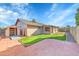 Backyard featuring a shed, grassy area, and a paved patio area for outdoor gatherings at 3523 W Kelton Ln, Phoenix, AZ 85053