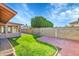 Landscaped backyard features a combination of lush green grass, brick pavers, and a block wall at 3523 W Kelton Ln, Phoenix, AZ 85053