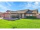 Charming single-story brick home with lush green lawn, mature landscaping, and a two-car garage at 3523 W Kelton Ln, Phoenix, AZ 85053