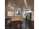 A spacious kitchen featuring an island with a granite countertop, stainless steel appliances, and tiled backsplash at 3523 W Kelton Ln, Phoenix, AZ 85053