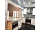 A modern kitchen showcasing an island with a granite countertop, stainless steel appliances, and custom white cabinets at 3523 W Kelton Ln, Phoenix, AZ 85053