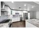 A modernized kitchen featuring new stainless steel appliances, granite countertops and custom white cabinetry at 3523 W Kelton Ln, Phoenix, AZ 85053