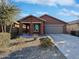 Charming single-story home featuring a well-maintained front yard and a two-car garage at 40995 W Portis Dr, Maricopa, AZ 85138