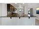 Modern kitchen featuring a breakfast bar, stainless steel appliances, and granite countertops at 40995 W Portis Dr, Maricopa, AZ 85138