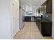 Well-lit kitchen with stainless steel appliances, dark cabinets, and tiled flooring at 40995 W Portis Dr, Maricopa, AZ 85138