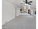 Open-concept living space with a large living room that opens to the kitchen area and a dining area at 40995 W Portis Dr, Maricopa, AZ 85138