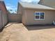 Side view of house showing the backyard gate, neutral paint color and light roof at 4124 E Apollo Rd, Phoenix, AZ 85042