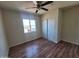 Bedroom featuring wood-look floors, ceiling fan and closet with sliding doors at 4124 E Apollo Rd, Phoenix, AZ 85042