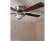 Close up of a ceiling fan with dark wooden blades at 4124 E Apollo Rd, Phoenix, AZ 85042