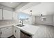 Bright kitchen featuring white cabinets, stainless steel appliances, and a view to the living area at 4737 E Belleview St, Phoenix, AZ 85008