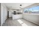 Modern kitchen with stainless steel appliances, white cabinets, and a spacious breakfast nook at 4737 E Belleview St, Phoenix, AZ 85008