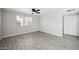 Bright living room featuring tile floors, ceiling fan, and a large window at 4737 E Belleview St, Phoenix, AZ 85008