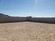 Large dirt backyard enclosed by a tall block wall, perfect for creating your own outdoor oasis at 48467 N Duran Way, Gold Canyon, AZ 85118