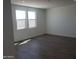 Bright bedroom with two windows and wood style tile flooring at 48467 N Duran Way, Gold Canyon, AZ 85118