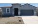 Charming single-story home with a gray exterior, covered entry, and two-car garage at 48467 N Duran Way, Gold Canyon, AZ 85118