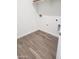Clean, minimalist laundry room with wood-style tile floor at 48467 N Duran Way, Gold Canyon, AZ 85118