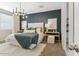 Well-lit main bedroom featuring modern chandelier and geometric accent wall at 48467 N Duran Way, Gold Canyon, AZ 85118