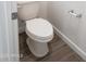 Clean, white toilet on wood-look tile flooring with a modern toilet paper holder at 48467 N Duran Way, Gold Canyon, AZ 85118