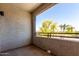 Balcony with stucco wall and rail overlooking mature trees and neighborhood at 5345 E Van Buren St # 308, Phoenix, AZ 85008
