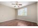 Bedroom featuring wood-look floors, a ceiling fan, and natural light from a window at 5345 E Van Buren St # 308, Phoenix, AZ 85008