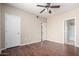 A spacious bedroom with wood-look flooring and a ceiling fan providing a comfortable living space at 5345 E Van Buren St # 308, Phoenix, AZ 85008