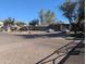 View of the apartment exterior with a circular, brick driveway with two cars parked outside of the homes at 5345 E Van Buren St # 308, Phoenix, AZ 85008
