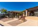 Exterior of property features a seating area, grill, and lush landscaping at 5345 E Van Buren St # 308, Phoenix, AZ 85008