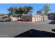Apartment complex garages with multiple beige garage doors, red fire hydrant, and desert landscaping at 5345 E Van Buren St # 308, Phoenix, AZ 85008