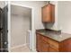 Large laundry room with granite counters and storage adjacent to washer and dryer hookups at 5345 E Van Buren St # 308, Phoenix, AZ 85008