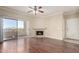 Bright living room features a fireplace, ceiling fan, and sliding glass doors to the balcony at 5345 E Van Buren St # 308, Phoenix, AZ 85008