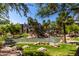 Scenic view of community pond featuring palm trees, rock features, and well-manicured landscaping at 5345 E Van Buren St # 308, Phoenix, AZ 85008