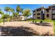 Community volleyball court with blue sky and lush greenery at 5345 E Van Buren St # 308, Phoenix, AZ 85008