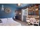 Comfortable bedroom with a large window, striped accent wall, and a cozy desk area at 5809 W Morten Ave, Glendale, AZ 85301